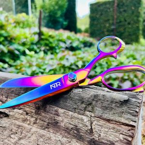 A pair of NTR Mane & Tail Shears sitting on a log.