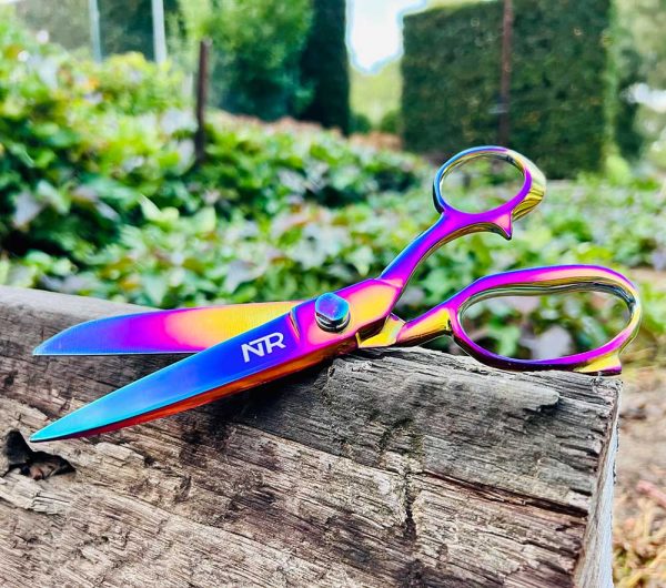 A pair of NTR Mane & Tail Shears sitting on a log.