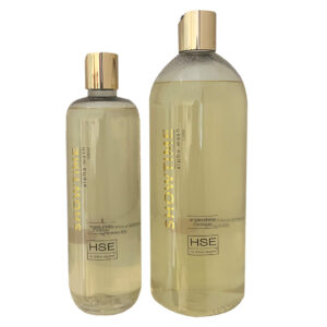 Two bottles of HSE Showtime Alpha Wash Shampoo and conditioner on a white background.