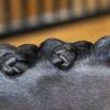 Captured in intimate detail, a horse's mane is styled into several tight, neatly woven braids that glisten as though polished with the meticulous care provided by a Sheepskin Polishing Mitt from NTR.